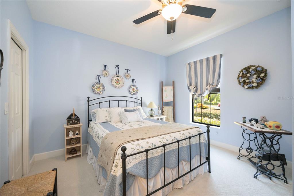 13202 Torresina Terrace Lakewood Ranch, FL 34211 - Photo 17 of 35 a bedroom with a bed and a table in it