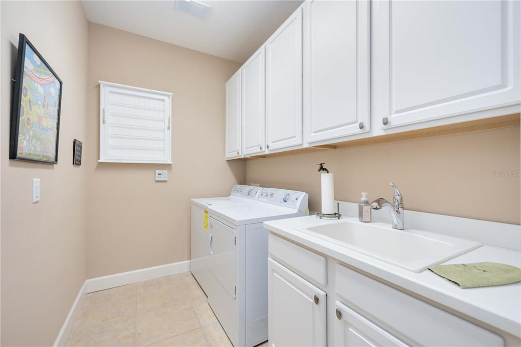 13202 Torresina Terrace Lakewood Ranch, FL 34211 - Photo 22 of 35 a utility room with sink dryer and washer