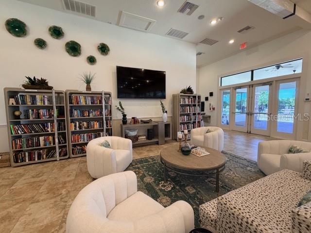 13202 Torresina Terrace Lakewood Ranch, FL 34211 - Photo 34 of 35 a living room with furniture and a flat screen tv