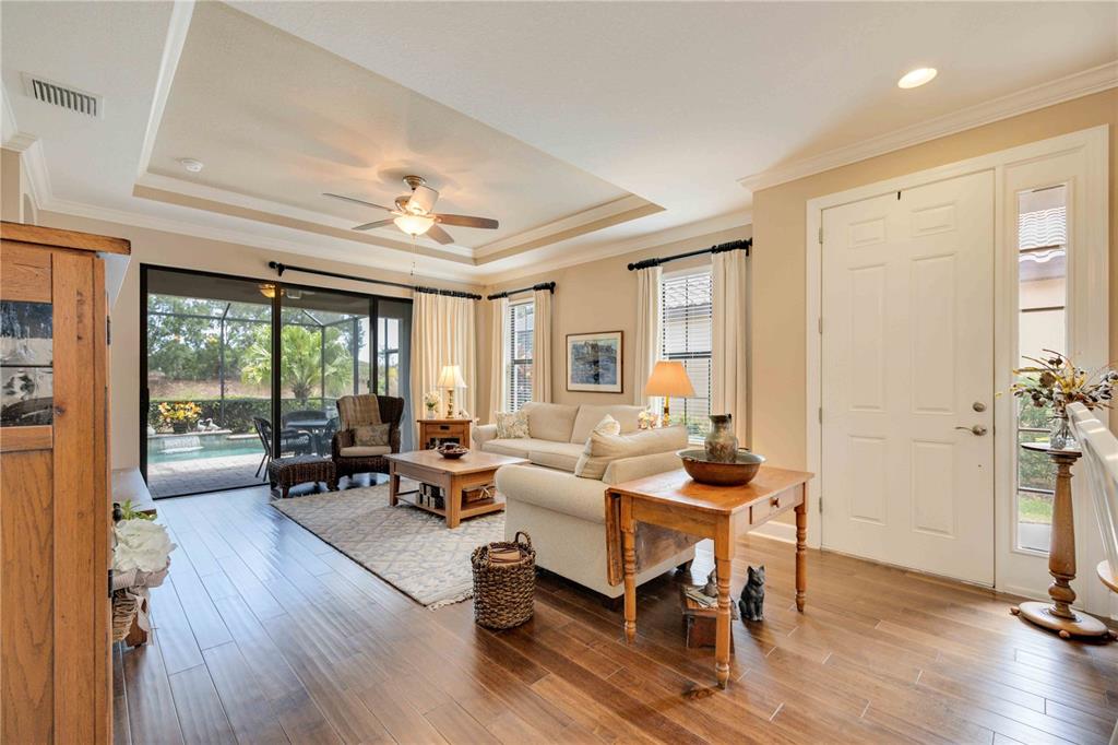 13202 Torresina Terrace Lakewood Ranch, FL 34211 - Photo 4 of 35 a living room with furniture and a wooden floor
