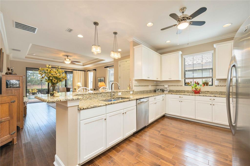 13202 Torresina Terrace Lakewood Ranch, FL 34211 - Photo 9 of 35 a large kitchen with granite countertop lots of counter space and window