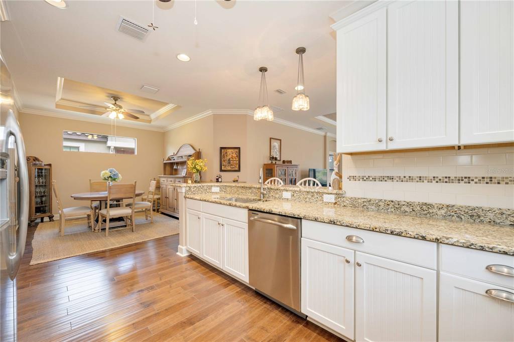 13202 Torresina Terrace Lakewood Ranch, FL 34211 - Photo 10 of 35 a kitchen with a sink cabinets and wooden floor