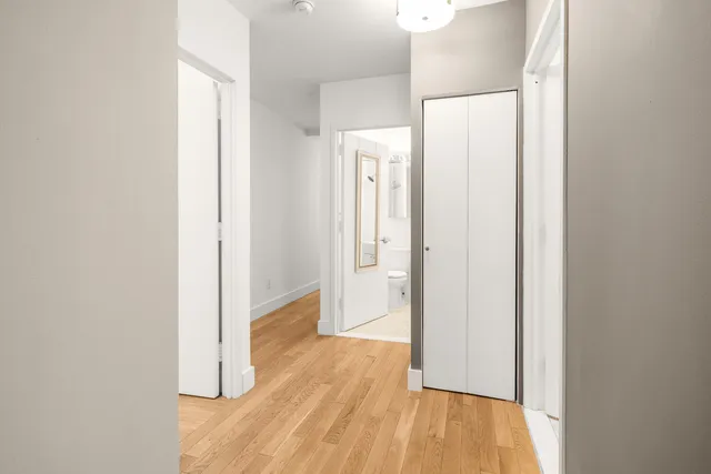 a view of a hallway with wooden floor