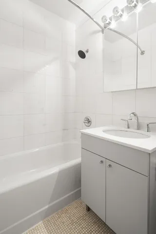 a bathroom with a sink a mirror and a bathtub