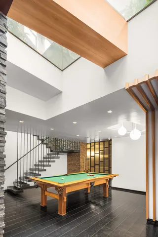 a room with lots of wooden furniture and windows