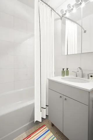 a bathroom with a sink a mirror and a bathtub