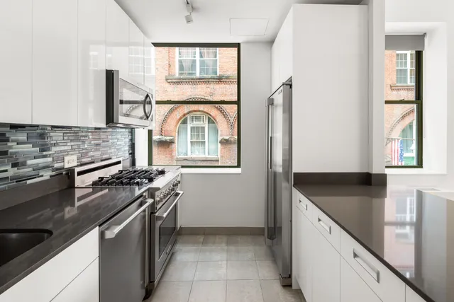 a kitchen with stainless steel appliances granite countertop a stove and a sink