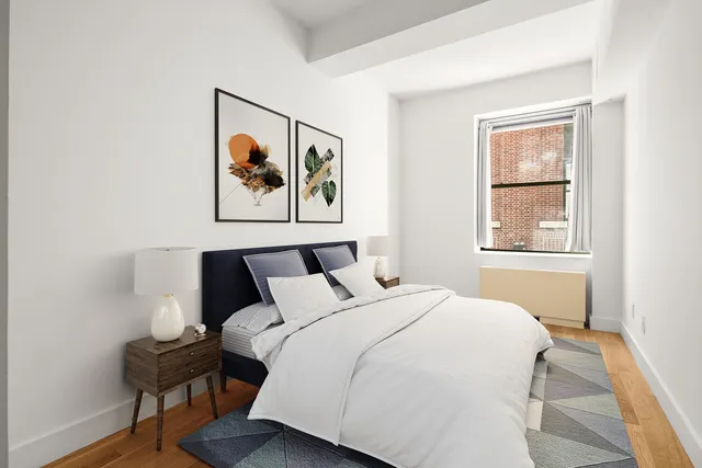 a bedroom with a bed and a painting on the wall