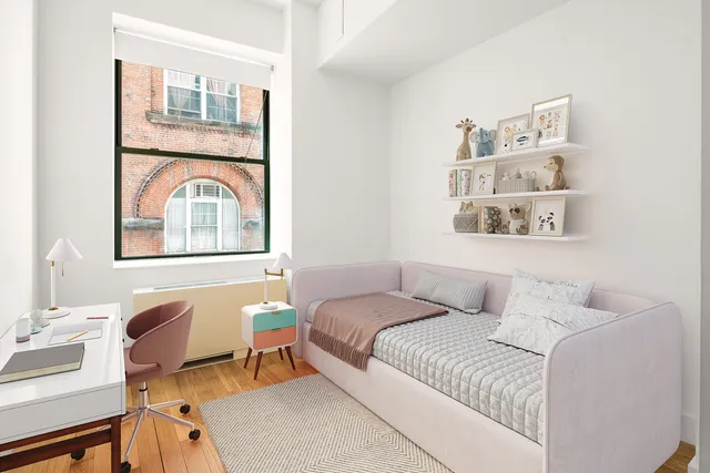 a bedroom with a bed and a desk