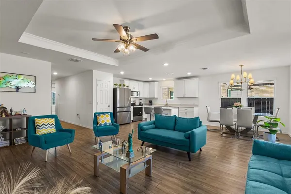 a living room with furniture and kitchen view