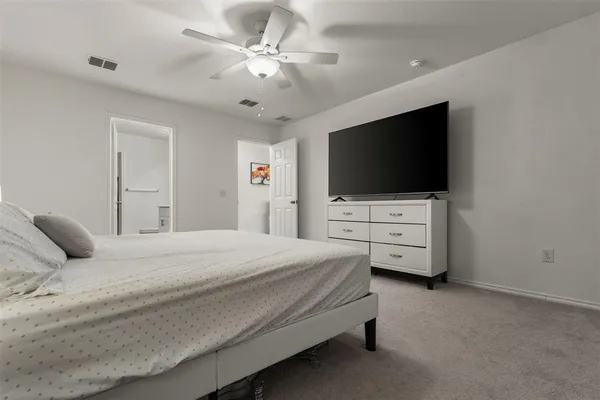 a bedroom with a bed and a flat screen tv