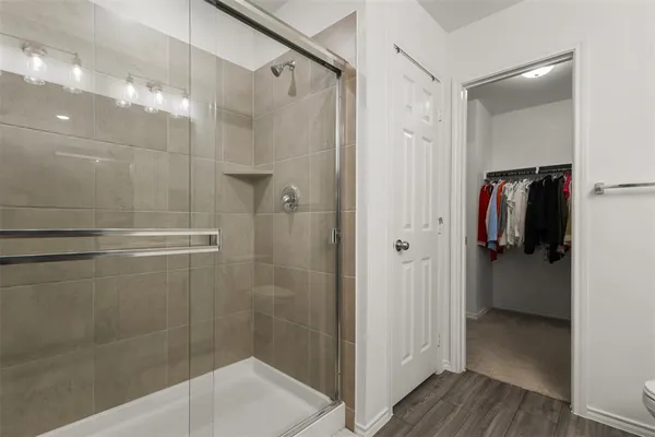 a bathroom with a shower and a glass door