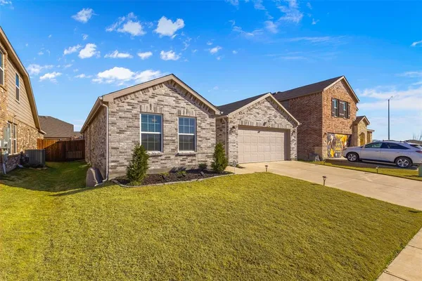 a view of a house with a big yard and large tree