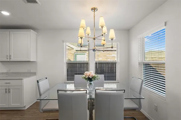 a view of a dining room with furniture and windows