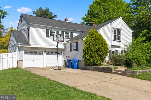 a view of a house with a yard and potted plants