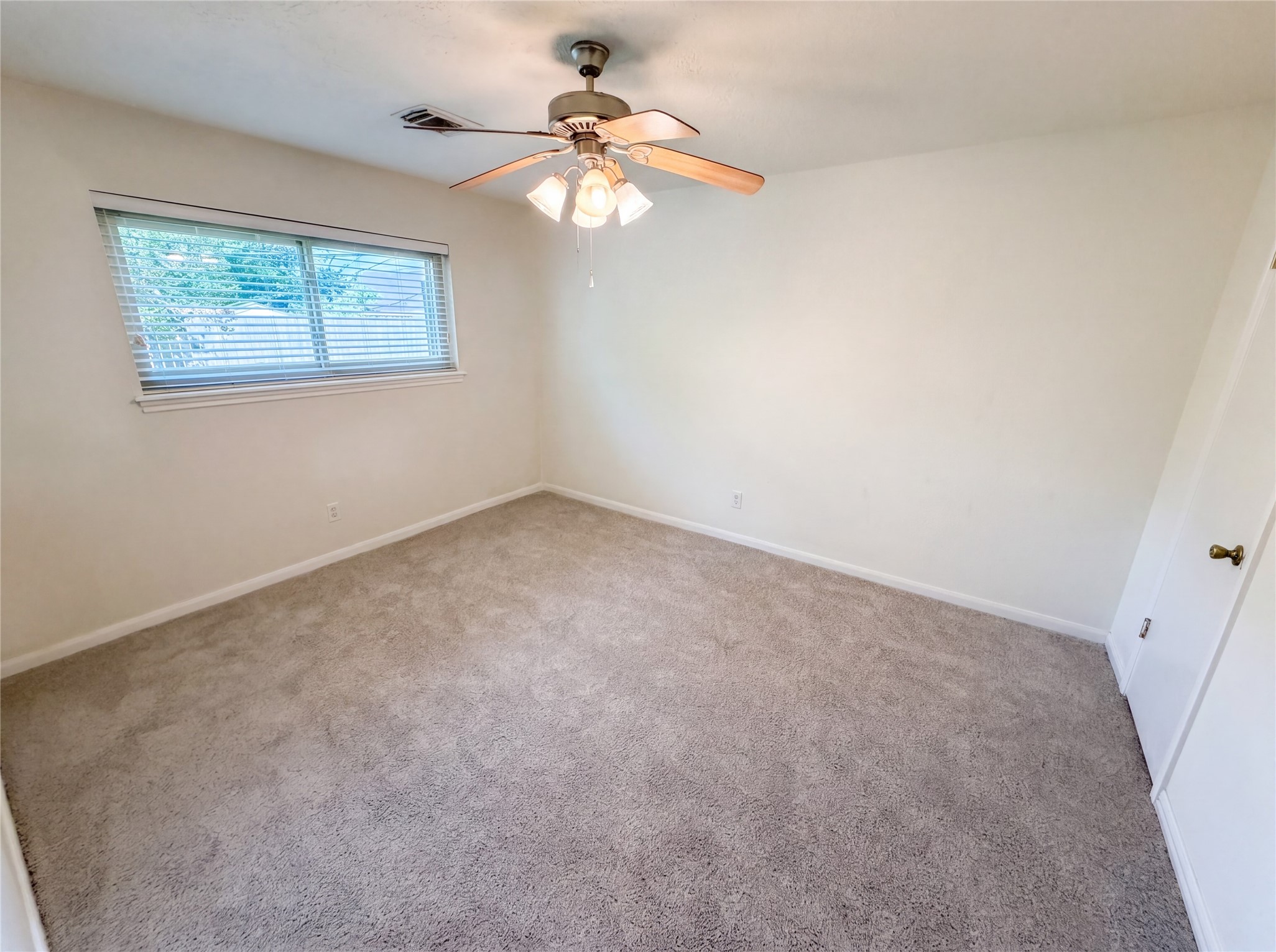 342 Queenstown Road Houston, TX 77015 - Photo 4 of 22 an empty room with windows and fan