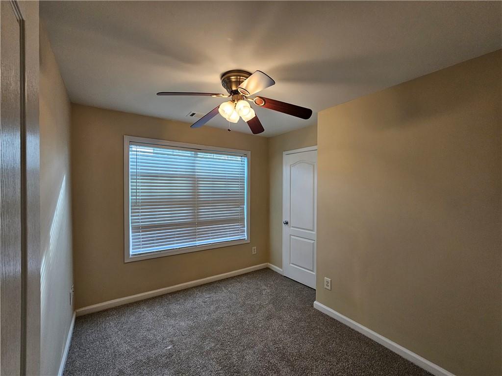 2160 Spikerush Way Buford, GA 30519 - Photo 13 of 29 a view of a livingroom with a ceiling fan and window