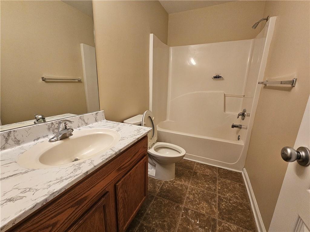 2160 Spikerush Way Buford, GA 30519 - Photo 18 of 29 a bathroom with a granite countertop sink toilet and shower