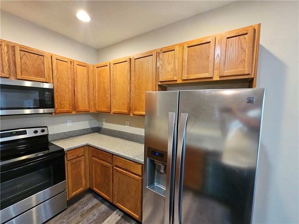 2160 Spikerush Way Buford, GA 30519 - Photo 2 of 29 a kitchen with granite countertop stainless steel appliances and wooden cabinets