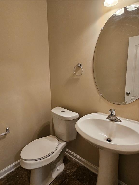 2160 Spikerush Way Buford, GA 30519 - Photo 25 of 29 a white toilet sitting next to a bathroom sink