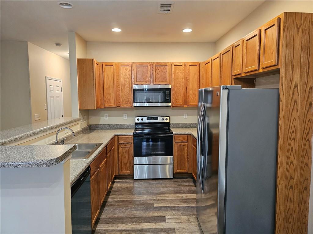 2160 Spikerush Way Buford, GA 30519 - Photo 3 of 29 a kitchen with granite countertop a refrigerator and a sink