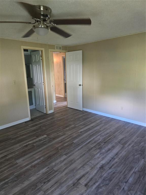 1705 Kiley Court The Villages, FL 32159 - Photo 14 of 20 a view of empty room with wooden floor and fan