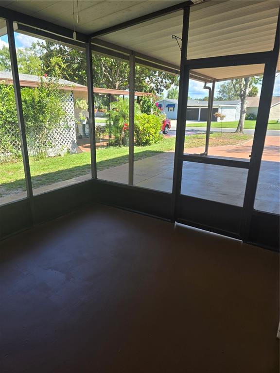 1705 Kiley Court The Villages, FL 32159 - Photo 17 of 20 a view of an empty room with wooden floor and a floor to ceiling window