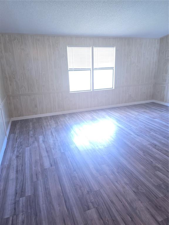 1705 Kiley Court The Villages, FL 32159 - Photo 7 of 20 an empty room with wooden floor and windows