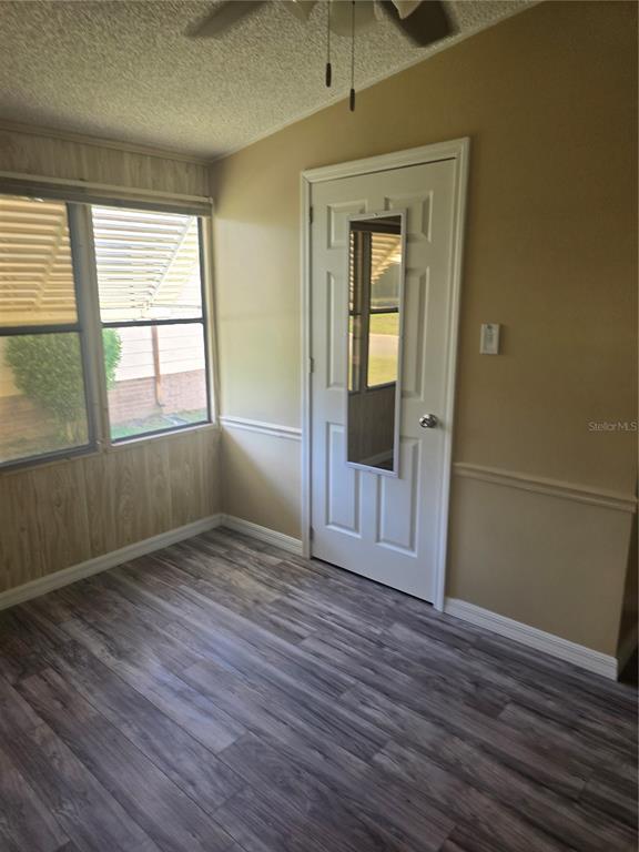 1705 Kiley Court The Villages, FL 32159 - Photo 8 of 20 an empty room with wooden floor and windows