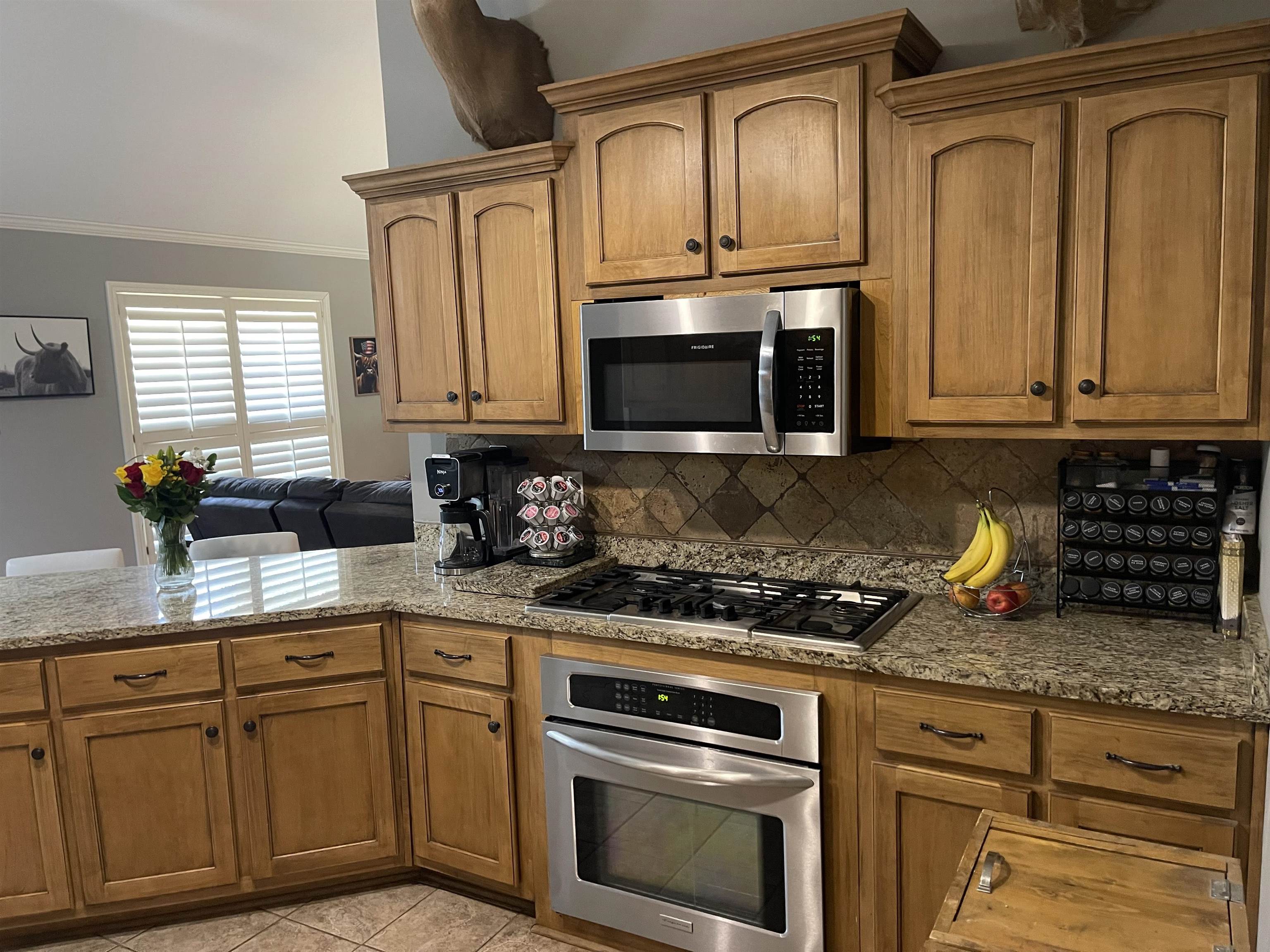 60 Mulberry Cove Oakland, TN 38060 - Photo 3 of 20 a kitchen with granite countertop stainless steel appliances a stove a microwave a sink and cabinets