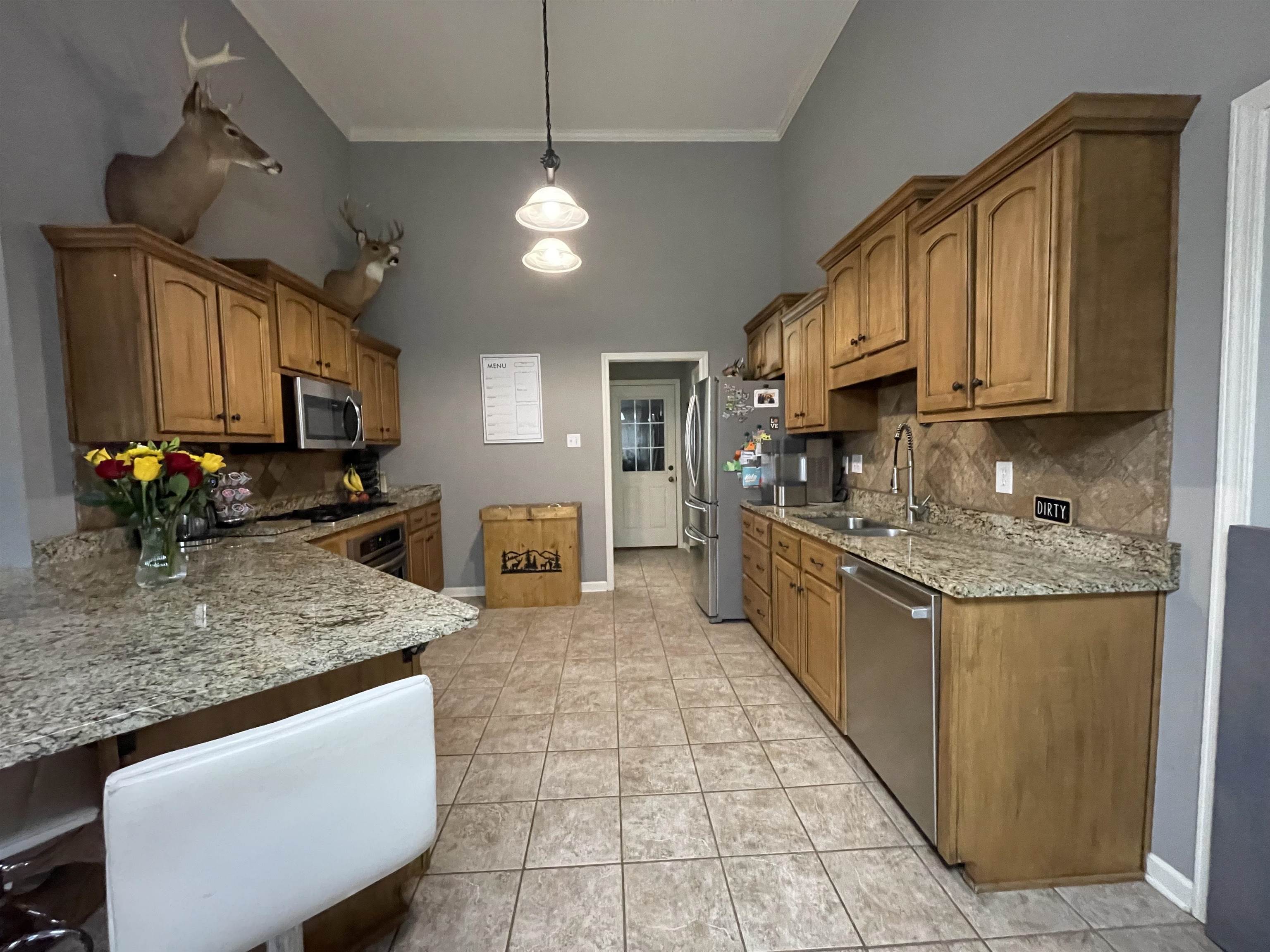 60 Mulberry Cove Oakland, TN 38060 - Photo 5 of 20 a kitchen with stainless steel appliances granite countertop a sink stove and refrigerator