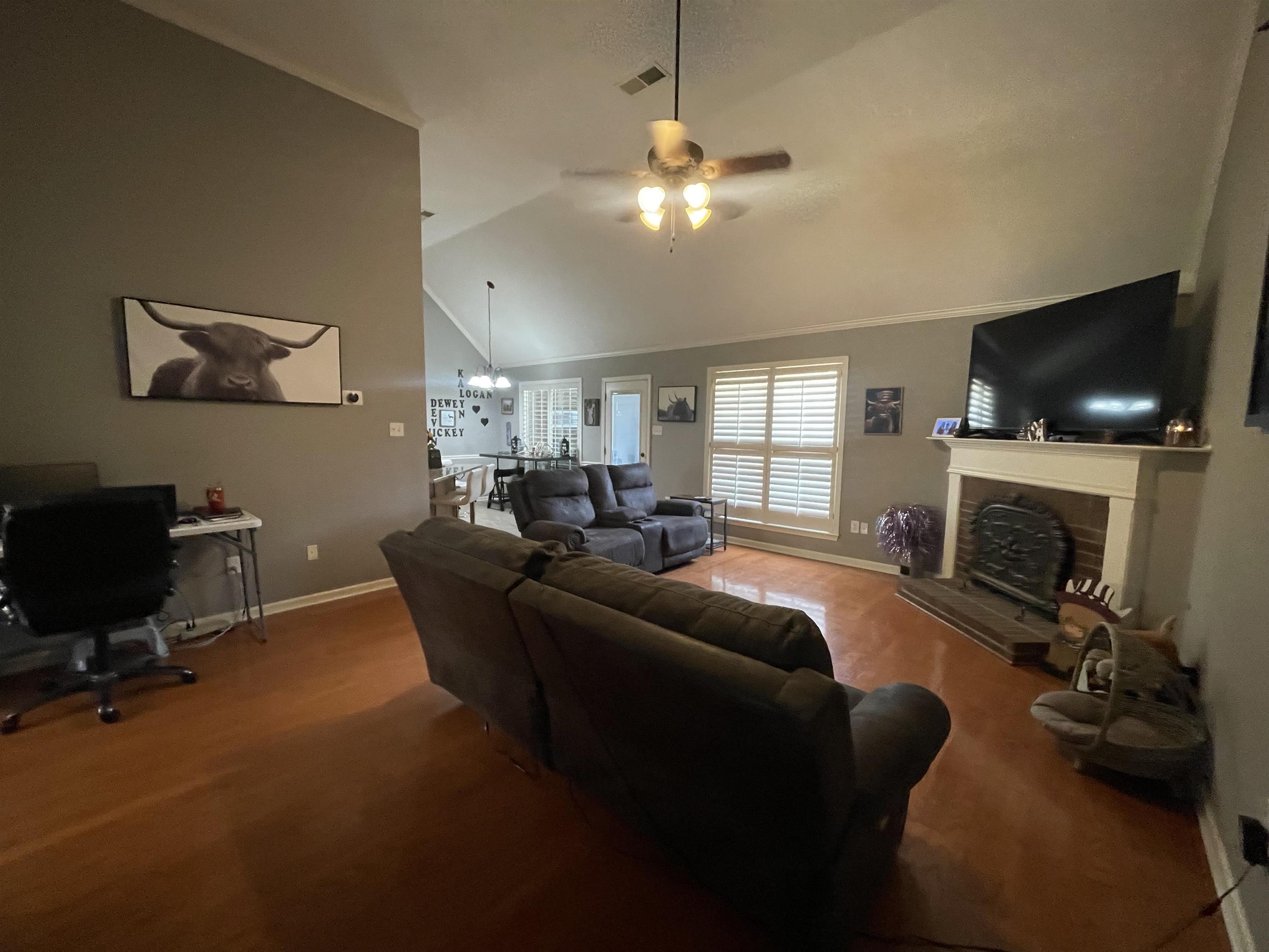 60 Mulberry Cove Oakland, TN 38060 - Photo 8 of 20 a living room with furniture a flat screen tv and a fireplace
