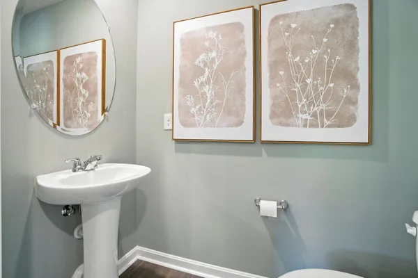 a bathroom with a sink mirror and toilet