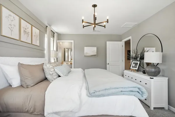 a bedroom with a bed and ceiling fan