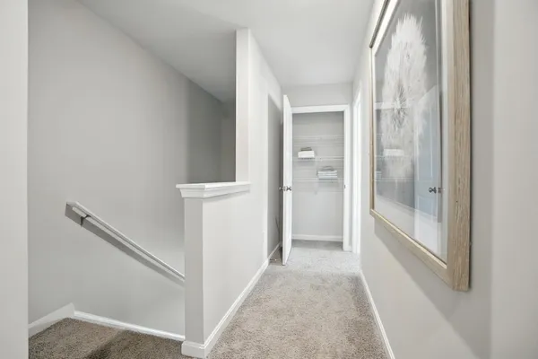 a view of a hallway with wooden floor and entryway