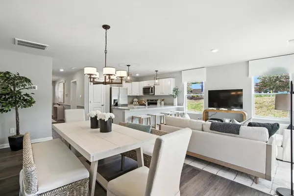 a view of a dining room with furniture and a chandelier