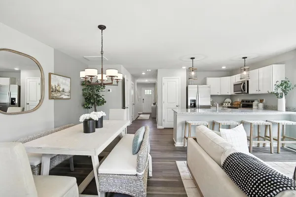 a large kitchen with a table and chairs