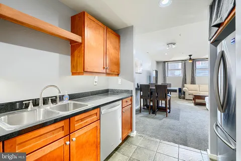 a kitchen with stainless steel appliances granite countertop sink stove and refrigerator