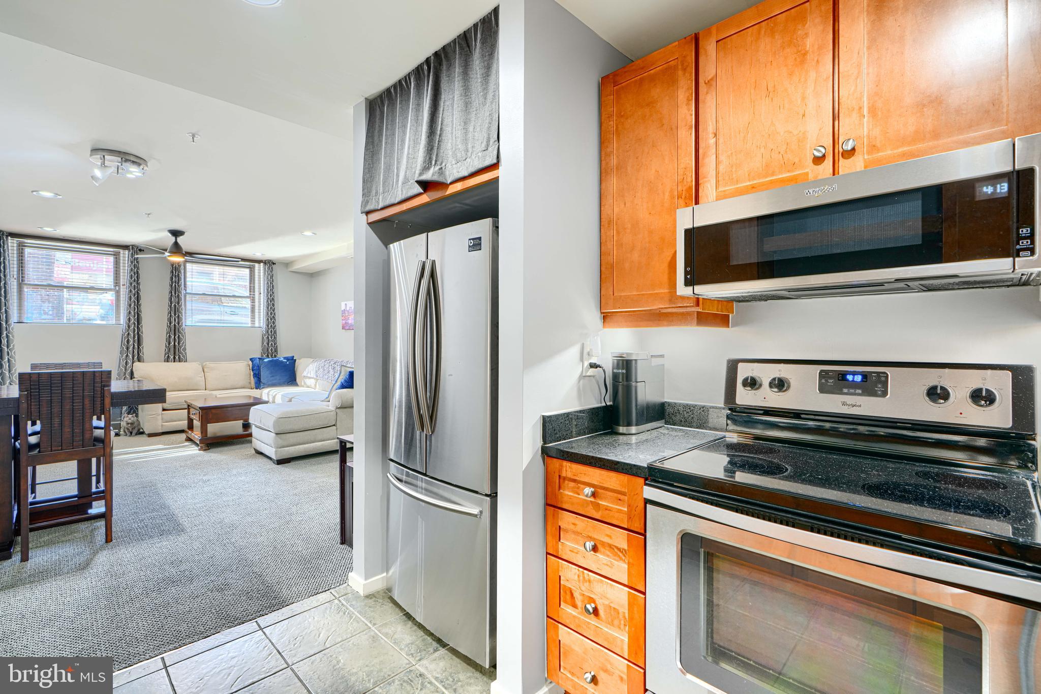 1211 Light Street, Unit T8 Baltimore, MD 21230 - Photo 13 of 33 a kitchen with stainless steel appliances a stove microwave and a refrigerator