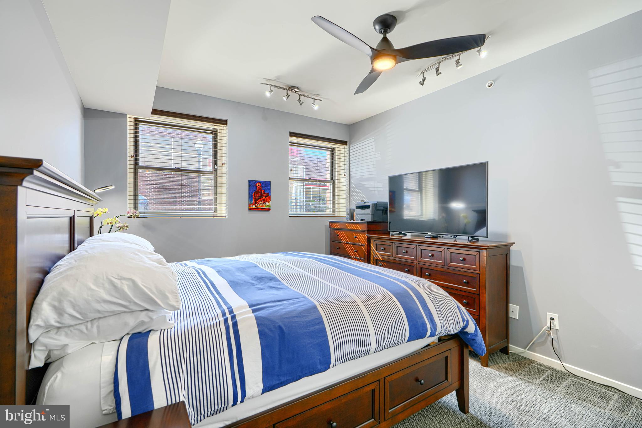 1211 Light Street, Unit T8 Baltimore, MD 21230 - Photo 15 of 33 a bedroom with a bed a chandelier and dresser