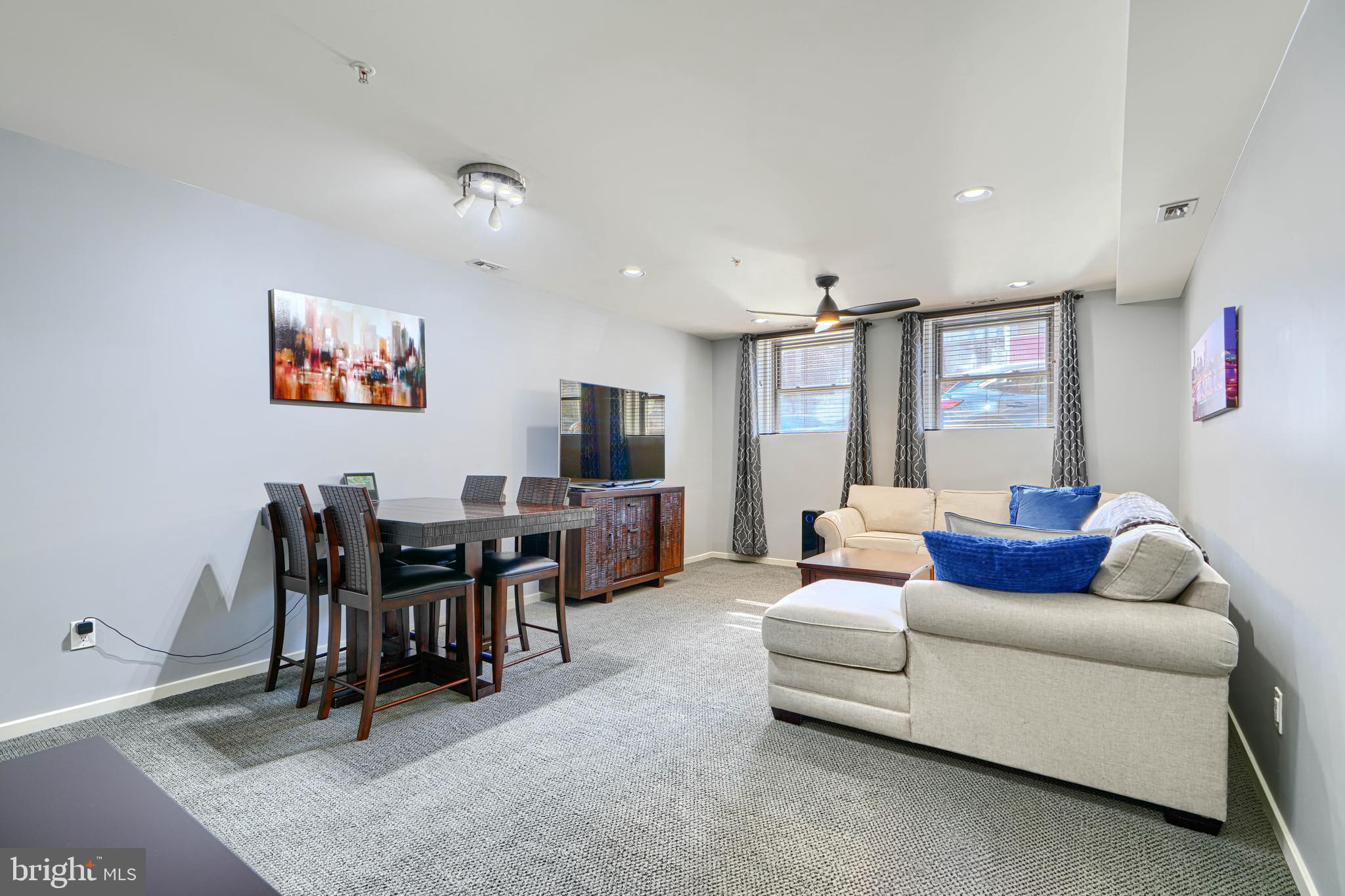 1211 Light Street, Unit T8 Baltimore, MD 21230 - Photo 2 of 33 a living room with furniture and a flat screen tv