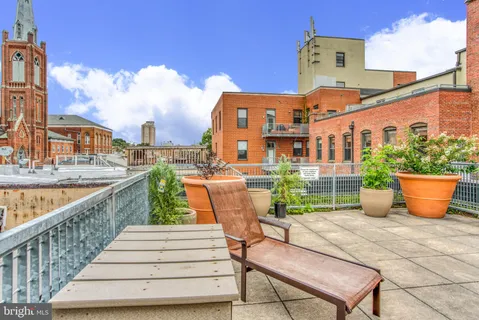 a view of a garden with tall buildings