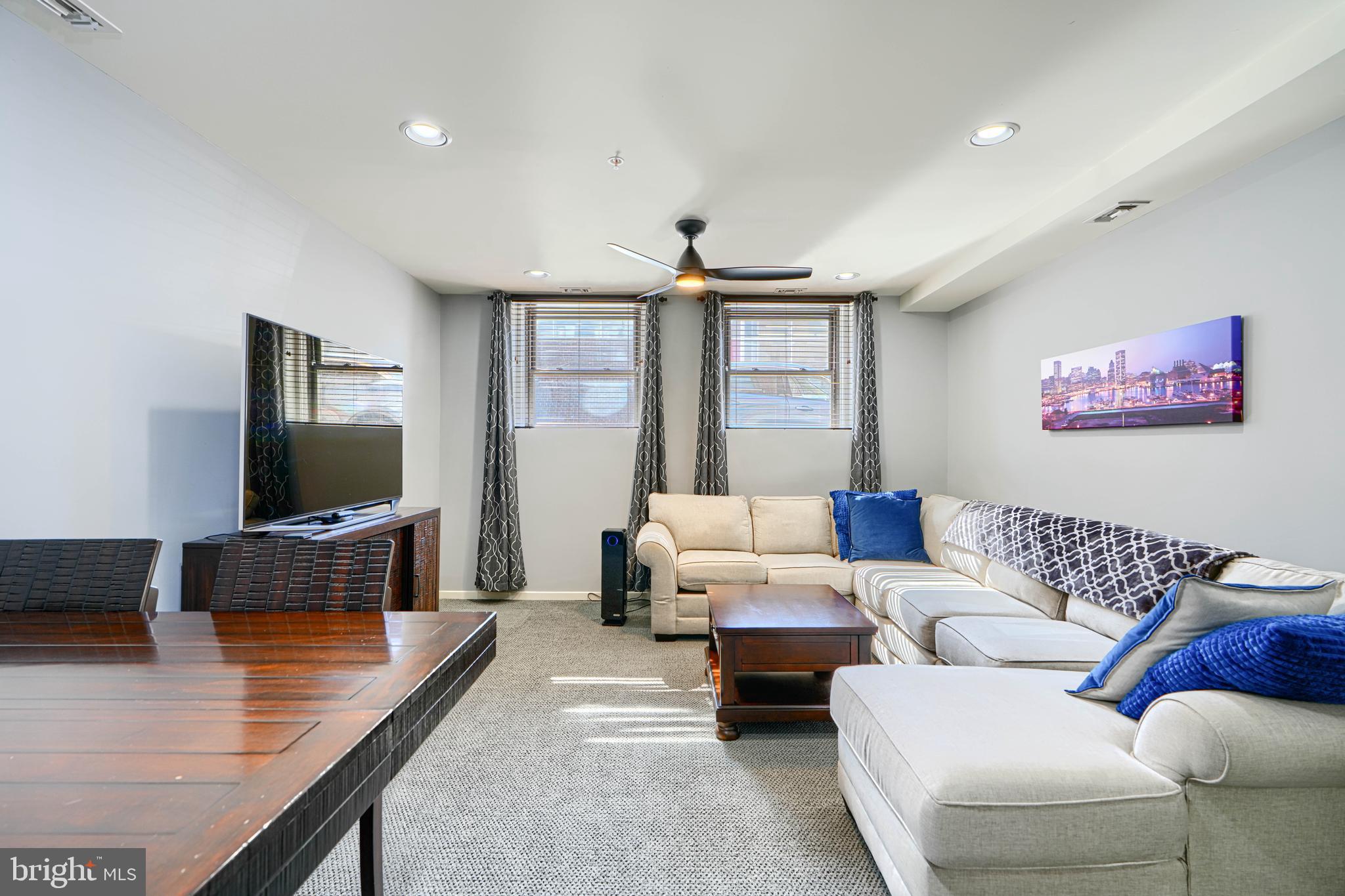 1211 Light Street, Unit T8 Baltimore, MD 21230 - Photo 4 of 33 a living room with furniture and a flat screen tv