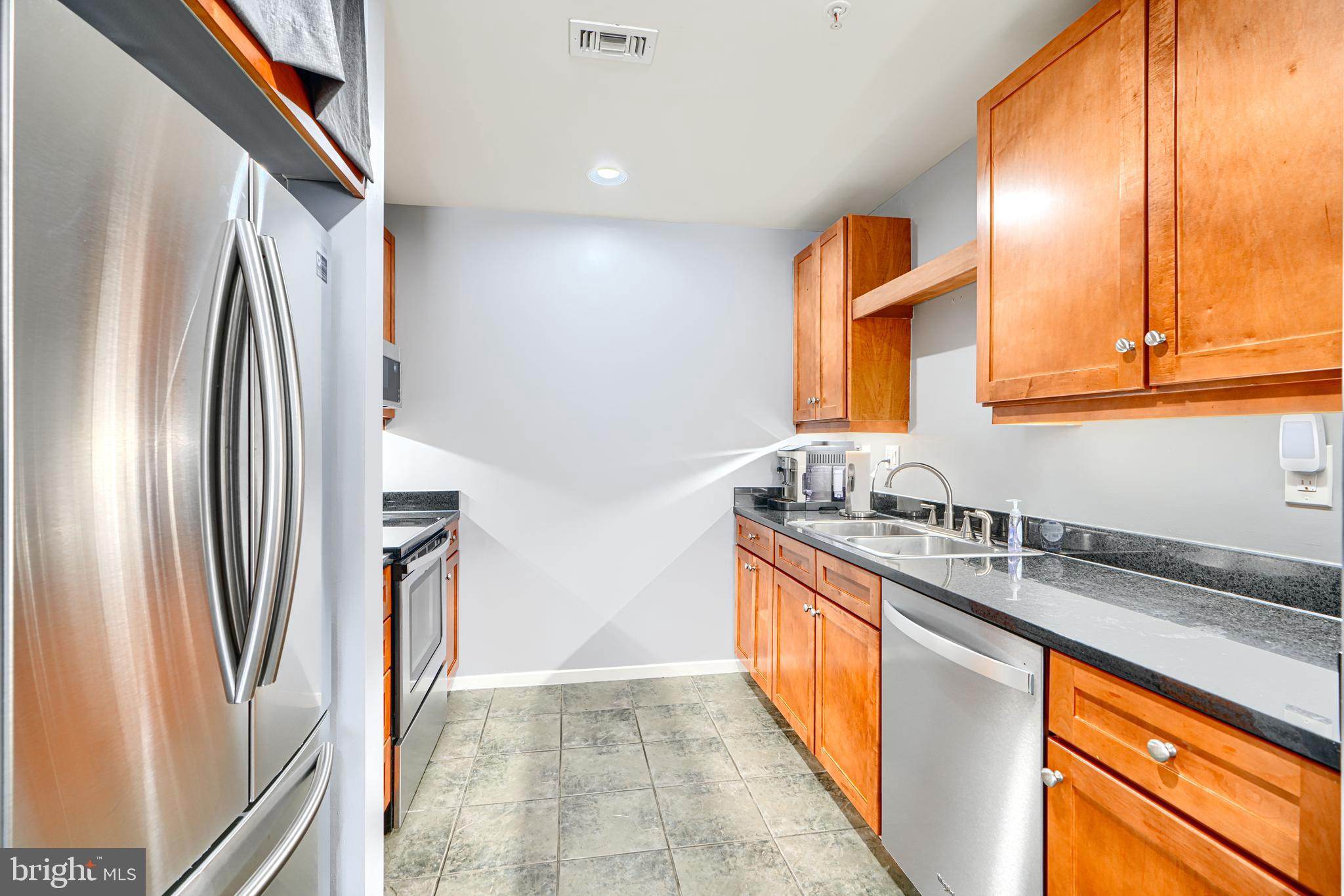 1211 Light Street, Unit T8 Baltimore, MD 21230 - Photo 10 of 33 a kitchen with stainless steel appliances granite countertop a refrigerator and a sink