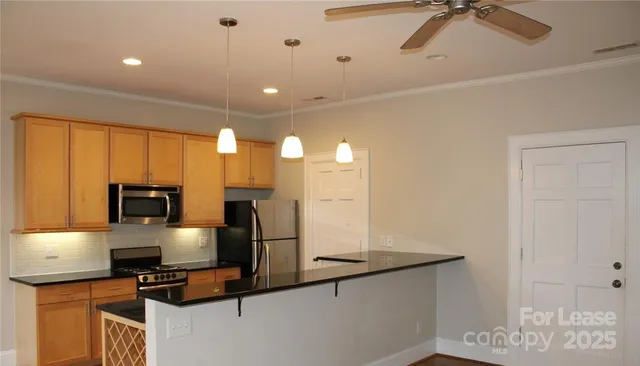 a kitchen with stainless steel appliances granite countertop a sink refrigerator and microwave