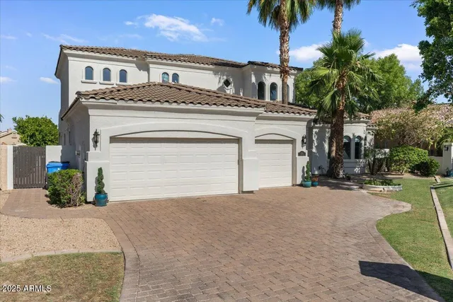 a view of a house with a yard and garage