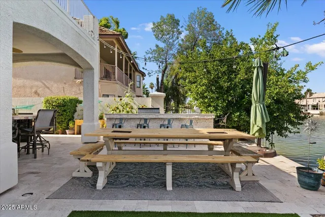 a bathroom with a granite countertop double vanity sink and mirror