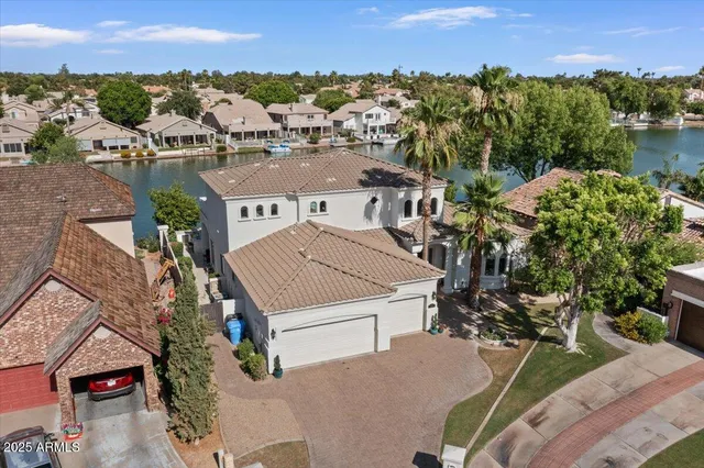 an aerial view of a house with a yard lake view and mountain view