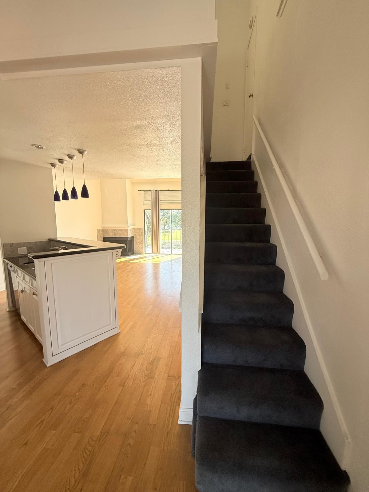 8287 Sands Point Drive, Unit 128 Houston, TX 77036 - Photo 11 of 30 a view of a kitchen with wooden floor and a stairs