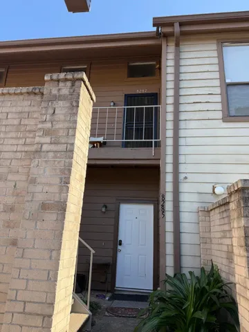 a front view of a house with plants